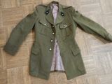 a green jacket on a wooden floor on the floor