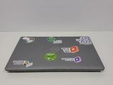 a laptop with stickers on it sitting on a table