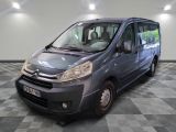 a picture of a small grey van parked in a garage