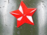 an image of a red star on top of a green helmet