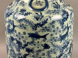 a blue and white vase with a bird design on it