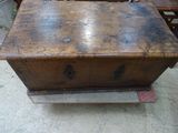 an old wooden chest sitting on top of a table