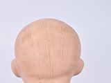 a wooden doll that has a tie on it ' s neck