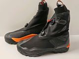pair of black and orange ski boots on a white surface