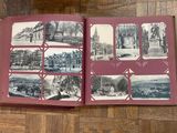 an open book on a wooden floor with pictures of old buildings