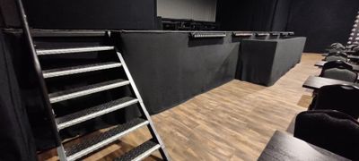 a room with a lot of chairs and ladders in it