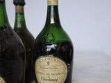 three bottles of wine are sitting on a marble counter top