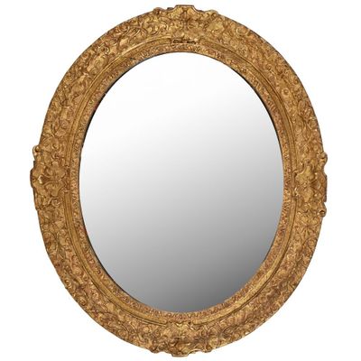 un miroir rond avec un cadre doré sur fond blanc
