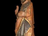 statue of a man with a beard and a robe holding a rosary