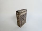 an old silver box sitting on top of a white table