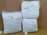 three bags of white rice sitting on top of a cardboard box