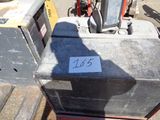 a box that has a number on it in the middle of a parking lot