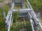 a pile of metal pipes sitting in the middle of a field