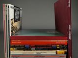 many books stacked on top of each other on a table