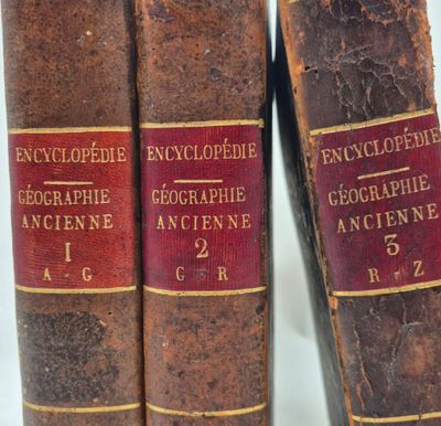 two old books are sitting on a shelf next to each other
