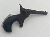 an old gun that is sitting on a white surface