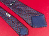 a close up of two ties on a red surface