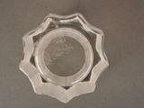 a small glass bowl with a silver rim on a table