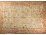 an antique rug with a pink border and a gold border