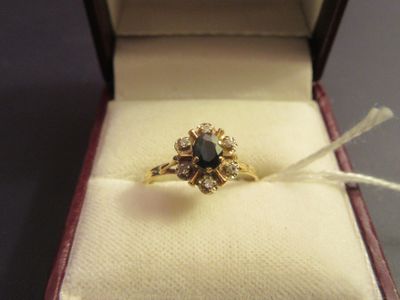 a gold ring with a black diamond in it in a box