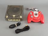 a video game console with a game controller next to it