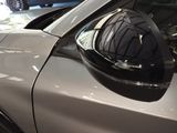 a reflection of a helmet on the side of a car
