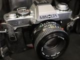 a camera with a lens attached to it on a black surface