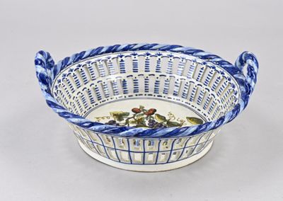 a blue and white basket with flowers in it