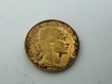 a close up of a gold coin on a white surface