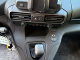 a car dashboard with a cell phone in the center