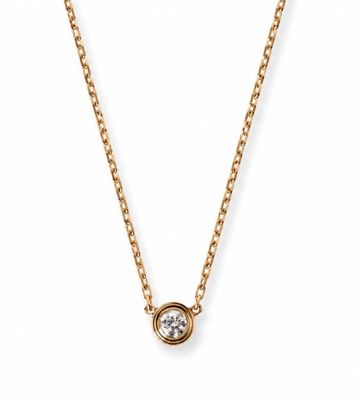 a gold necklace with a single diamond on a chain