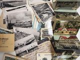 several old postcards are stacked on top of each other on a table