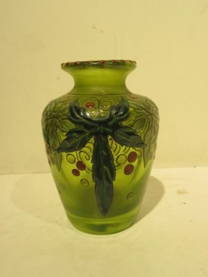a green vase with a dragonfly design on it