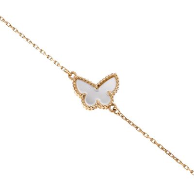 a white butterfly bracelet on a gold chain