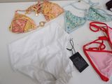 a lot of underwear and a pair of shoes on a table