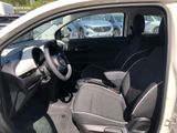 the interior of a small car with a steering wheel and seat covers