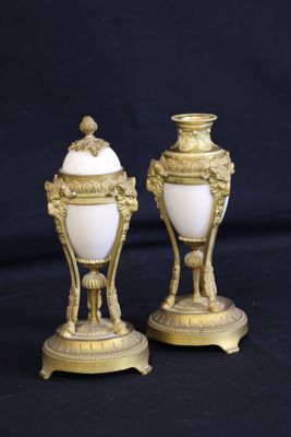 pair of antique gold and white vases on a black background