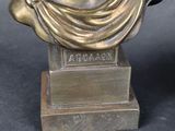 bronze bust of a man with a scarf around his neck