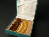 une boîte verte contenant six cuillères en or