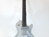 a guitar that is sitting on a stand on a white background