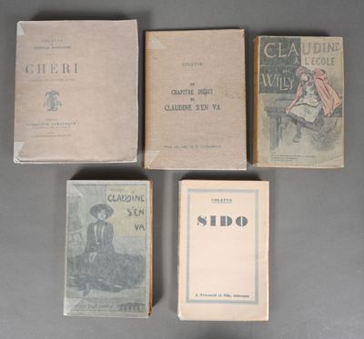 several old books sitting on top of a table next to each other
