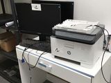 a printer sitting on top of a desk next to a computer