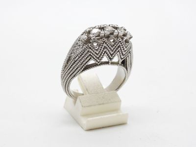 gros plan d'une bague en argent sur une surface blanche