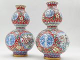 pair of chinese vases with colorful designs on them on a white background