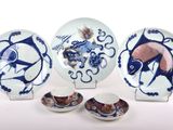 several pieces of blue and white plates and bowls with designs on them