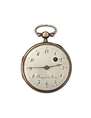 a silver pocket watch with roman numerals on it