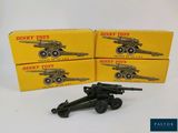 two boxes of dinky toys with a toy gun on top of them