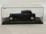 a black and blue model of a car in a glass case