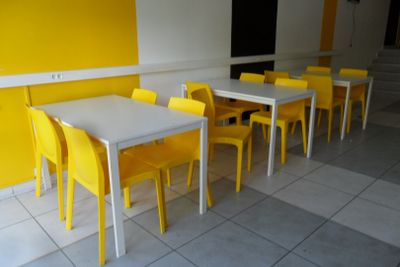 yellow chairs and a white table in a yellow room