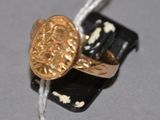 a gold ring with a black and white design on it